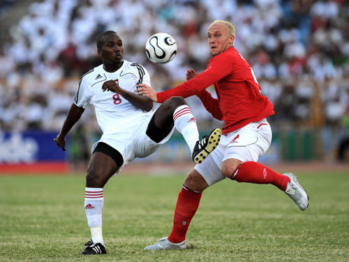 Photo: Trinidad and Tobago midfielder Khaleem Hyland (left) holds off former England striker Dean Ashton during an international friendly on 4 May 2008 in Port of Spain. Hyland has spent his last seven years as a professional player in Belgium.