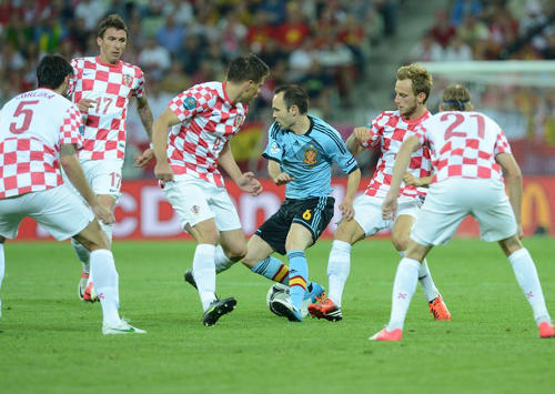 Photo: Spain midfield star and World Cup, Euro Cup and Champions League winner Andrés Iniesta (centre) bewitches half the Croatian team during the Euro 2012 competition. Iniesta's first major tournament was at the Trinidad and Tobago 2001 Under-17 World Cup where he played at the Mannie Ramjohn Stadium.