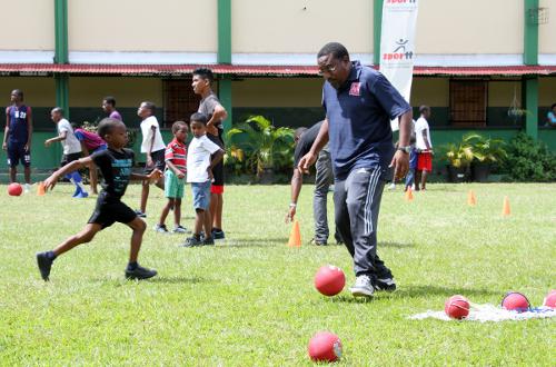 Photo: Former Trinidad and Tobago co-head coach and Morvant Caledonia United co-founder Jamaal Shabazz (right) helps out at a SPORTT Company Easter Camp in 2013. (Courtesy SPORTT Company)