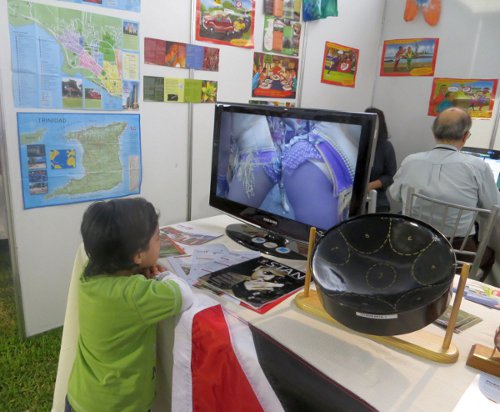 Photo: A Peruvian boy sees something he likes in a T&T Carnival DVD. (Courtesy Juliet Solomon/Wired868)