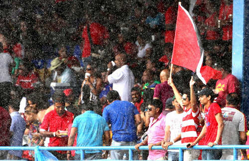 Photo: West Indies cricket fans make themselves busy during a rained out fixture at the Queen's Park Oval in 2013. (Courtesy Westindiescricket)