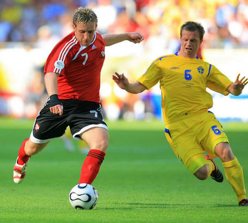 Photo: Trinidad and Tobago midfielder Chris Birchall (left) goes for goal against Sweden at the 2006 World Cup. Birchall, who was born in England retired from international football in 2013, is Trinidad and Tobago's most successful imported player.