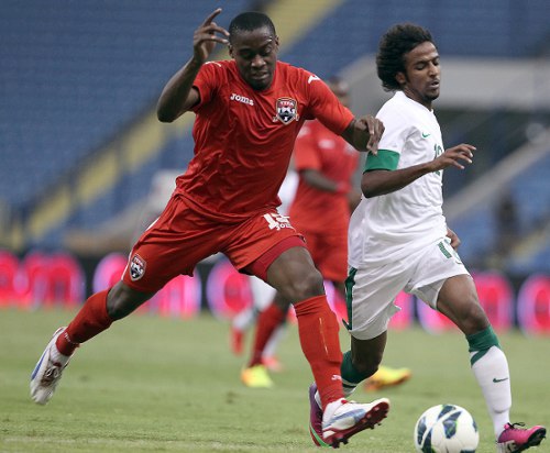 Photo: Trinidad and Tobago defender Robert Primus (left) in action against Saudi Arabia in 2013. (Courtesy TTFA Media)