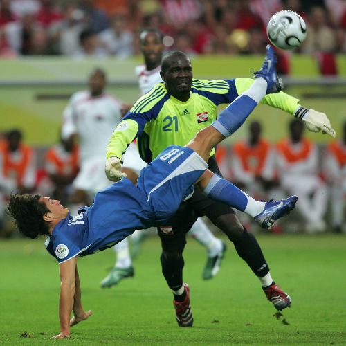 Photo: Trinidad and Tobago goalkeeper Kelvin Jack wrestles with Paraguay forward Nelson Valdez (left) during the 2006 World Cup. (Copyright AFP 2014/Roberto Schmidt)