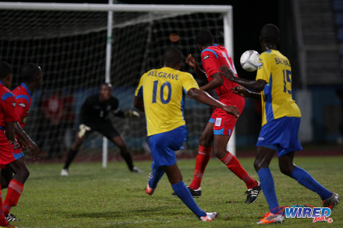 Photo: Defence Force midfielder Josimar Belgrave (centre) curls his shot around St Ann's Rangers defender Tevin Gilkes and into the far corner. (Courtesy Allan V Crane/Wired868)