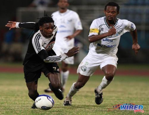 Photo: W Connection captain Gerard Williams (right) tracks Central FC winger Jason Marcano during the 2014 Lucozade Sport Goal Shield final. (Courtesy Allan V Crane/Wired868)