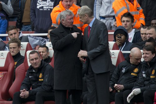 Photo: Former Manchester United manager Sir Alex Ferguson (left) exchanges words with his Arsenal counterpart Arsene Wenger. (Copyright AFP 2014/Adrian Dennis)