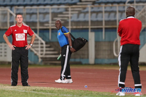 Photo: Then Central FC coach Terry Fenwick (left) and North East Stars coach Angus Eve glare at each other during their 2014 Digicel Pro Bowl quarterfinal clash. (Courtesy Allan V Crane/Wired868)