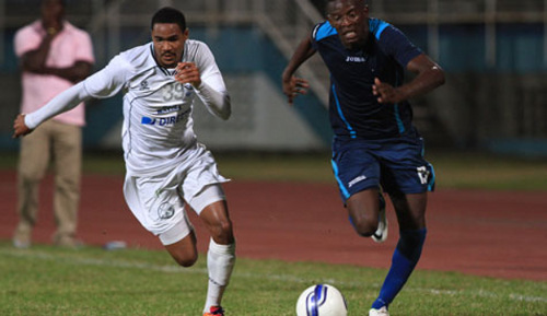 Photo: Police FC striker Jameel Perry (right) tries to get past W Connection right back Alvin Jones during a 2013/14 Pro League fixture. (Courtesy TT Pro League)