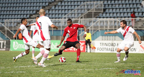 Photo: Trinidad and Tobago defender Sheldon Bateau (centre) in friendly action against Peru at the Ato Boldon Stadium, Couva. (Courtesy Allan V Crane/Wired868)