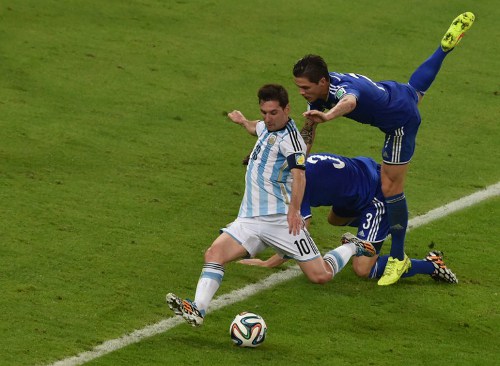 Photo: Argentina forward and captain Lionel Messi (left) has been stockpiling defenders whole tournament. (Copyright AFP 2014/Yasuyoshi Chiba)