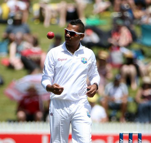 Photo: West Indies spinner Sunil Narine prepares to bowl against New Zealand at Seddon Park, Hamilton on 21 December 2013. (Copyright AFP 2014/Michael Bradley)