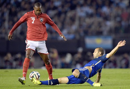 Photo: Trinidad and Tobago midfielder Ataulla Guerra (left) takes on Argentina midfielder Javier Mascherano during a friendly on 4 June 2014. (Copyright AFP 2014/Daniel Garcia)