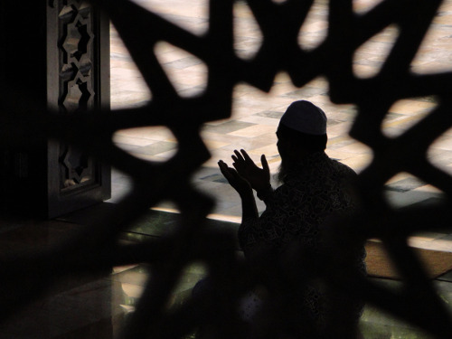 Photo: A Muslim observes prayer time.