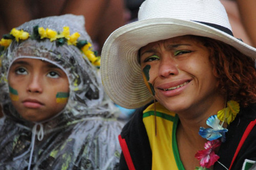 Photo: Brazil football fans celebrate then Trinidad and Tobago prime minister Kamla Persad-Bissessar's visit to Belo Horizonte. Too bad about the 7-1 loss to Germany which, coincidentally, happened on that same day... (Copyright AFP 2014/Tasso Marcelo)