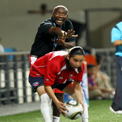 Photo: Trinidad and Tobago women's national under-15 coach Marlon Charles (background) instructs his team during an international fixture against Chile in the Singapore 2010 Youth Olympic Games (YOG) at the Jalan Besar Stadium in Singapore, Aug 12, 2010. Chile won 1-0. (Courtesy SPH-SYOGOC/Seyu Tzyy Wei)