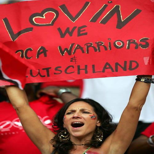 Photo: A Trinidad and Tobago supporter holds up a sign ahead of the Group B World Cup match between Paraguay and Trinidad and Tobago at Kaiserslautern's Fritz-Walter Stadium on 20 June 2006. (Copyright AFP 2014/Roberto Schmidt)