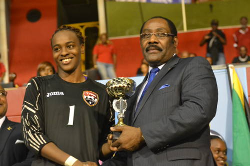 Photo: Trinidad and Tobago goalkeeper Kimika Forbes (left) receives the 2014 Caribbean Cup Best Goalkeeper prize from CFU executive member Horace Burrell. (Courtesy Jinelle James/WOLF)