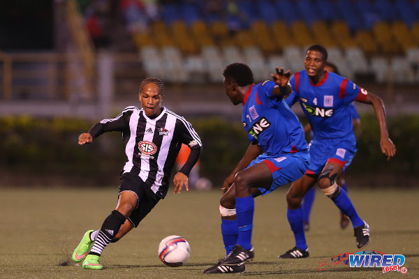 Photo: Central FC attacker Nathaniel Garcia (left) runs at St Ann's Rangers defenders Trevin Latapy (centre) and Jelani Peters during the 2014/15 Pro League season. (Courtesy Allan V Crane/Wired868)