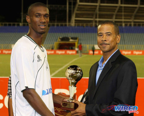 Photo: W Connection attacker Hashim Arcia (left) collects the 2013 Charity Shield MVP award from Pro League CEO Dexter Skeene. (Courtesy Wired868)