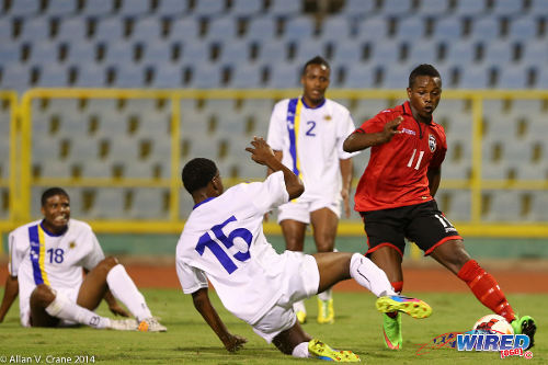 Photo: Trinidad and Tobago winger Levi Garcia (right) bamboozles the Curaçao defence during a 2014 U-20 Caribbean Cup fixture. Garcia, 18, is still eligible to represent the Trinidad and Tobago National Under-20 Team. (Courtesy Allan V Crane/Wired868)