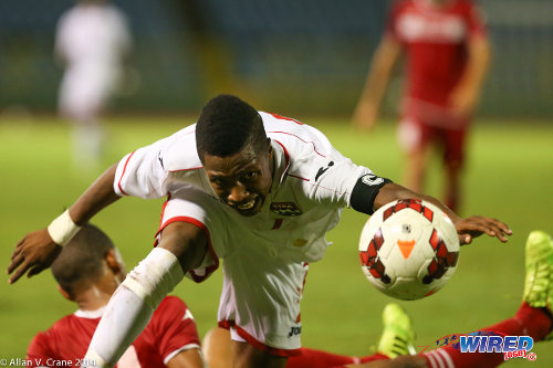 Photo: Trinidad and Tobago right back Shannon Gomez (right) battles for possession against Cuba during the 2014 Under-20 Caribbean Cup. (Courtesy Allan V Crane/Wired868)