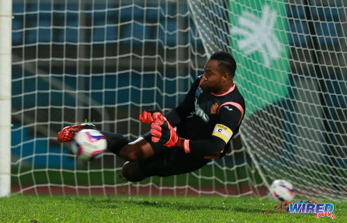 Photo: North East Stars captain and goalkeeper Cleon John saves a penalty against San Juan Jabloteh during the 2014 First Citizens Cup semifinals at the Ato Boldon Stadium. (Courtesy Allan V Crane/Wired868)