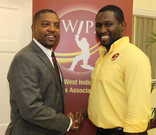 Photo: WIPA president Wavell Hinds (right) and WICB president Dave Cameron exchange pleasantries at the opening of WIPA's new office in Jamaica in 2014. (Courtesy WIPA)