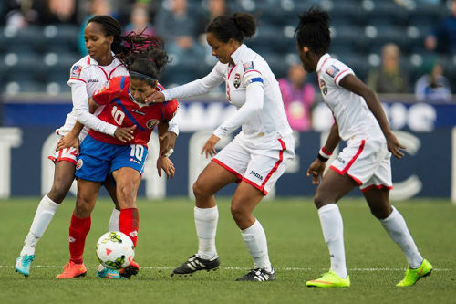 Photo: Trinidad and Tobago players (from left) Ahkeela Mollon, Maylee Attin-Johnson and Kennya Cordner try to close down Costa Rica playmaker and captain Shirley Cruz during the 2014 Women's CONCACAF Championship semifinal. (Courtesy CONCACAF)