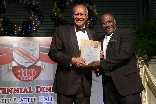 Photo: Former Trinidad and Tobago stand-out player and coach Everald "Gally" Cummings (right) is recognised by former President Maxwell Richards at the TTFF Centennial function.