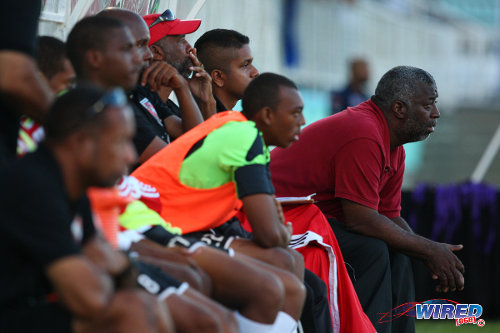 Photo: St Anthony's College coach Nigel Grosvenor (right) looks on from the bench during their 2014 Big Four fixture against Naparima College at the Mannie Ramjohn Stadium, Marabella. (Courtesy Allan V Crane/Wired868)