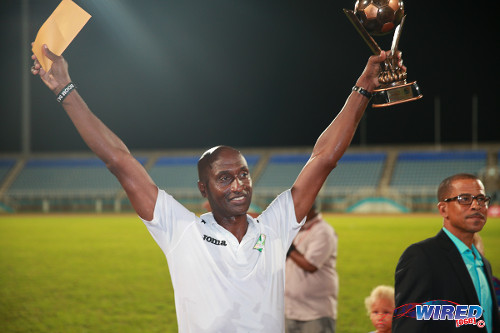 Photo: San Juan Jabloteh coach Keith Jeffrey (left) celebrates with the Best Coach trophy from the 2014 Toyota Classic competition. Looking on is Pro League CEO Dexter Skeene. (Courtesy Allan V Crane/Wired868)