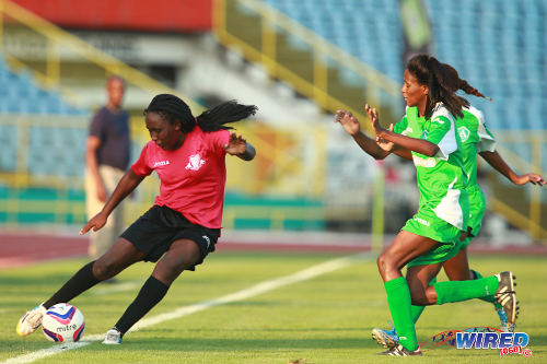 Photo: Point Fortin East Secondary student Denicia Prince (left) takes on two St Augustine Secondary defenders in the 2014 Coca Cola Girls' National Intercol final. (Courtesy Allan V Crane/Wired868)