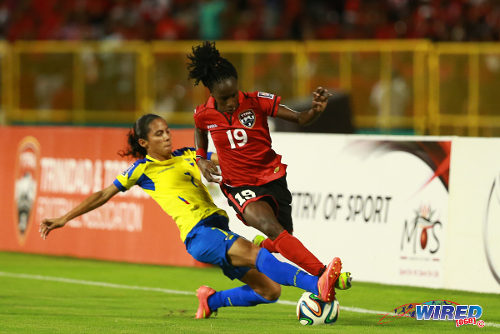 Photo: Trinidad and Tobago attacker Kennya Cordner (right) tries to escape a challenge from Ecuador right back Ingrid Rodriquez during their FIFA Play Off second leg meeting in Port of Spain on 2 December 2014. (Courtesy Allan V Crane/Wired868)