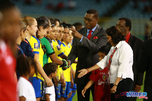 Photo: Former TTFA president and ex-Port of Spain Mayor Raymond Tim Kee (centre) gestures to an Ecuador player while former Prime Minister Kamla Persad-Bissessar (right) has a word to her grandson before kick off of the FIFA Women's World Cup Play Off second leg on 2 December 2014. (Courtesy Allan V Crane/Wired868)