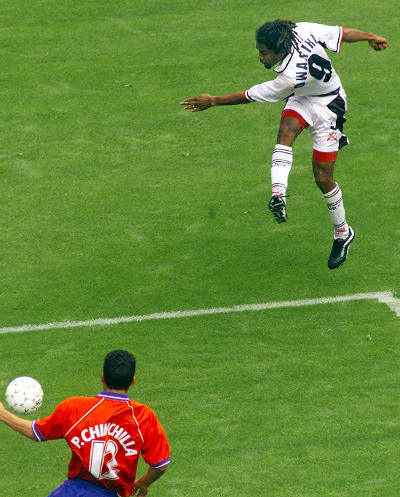 Photo: Trinidad and Tobago attacker Arnold Dwarika (top) drives home his country's opening goal in the 2000 CONCACAF Gold Cup quarter-final against Costa Rica. Dwarika is a former SSFL champion with Malick Secondary. (Copyright AFP 2015)