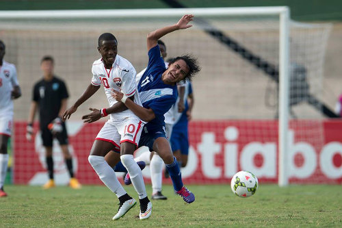 Photo: Trinidad and Tobago National Under-20 midfielder Jabari Mitchell (left) tangles with Guatemala attacker Mario Hernandez during CONCACAF action in Jamaica. (Courtesy CONCACAF)