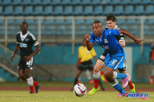 Photo: Defence Force midfielder Curtis Gonzales (centre) beats Central FC's Sean De Silva to the ball during 2014/15 Pro League action. (Courtesy Allan V Crane/Wired868)