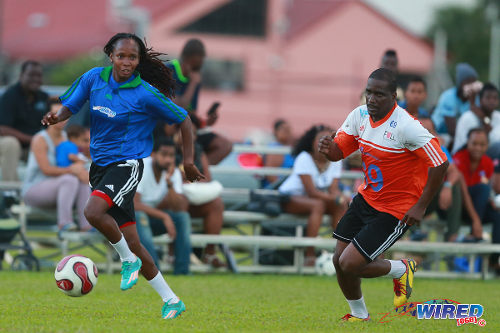 Photo: Trinidad and Tobago national women's team winger Ahkeela Mollon (left) takes former national youth team midfielder Lorne Joseph for a run during the 2015 Wired868 Football Festival at the UWI SPEC ground in St Augustine. (Courtesy Allan V Crane/Wired868)