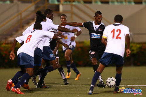 Photo: Central FC attacking midfielder Ataulla Guerra (second from right) takes on the entire Caledonia AIA defence during a 2015/16 Pro League match. (Courtesy Allan V Crane/Wired868)