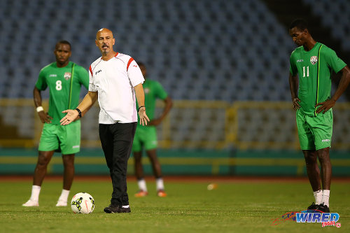 Photo: Trinidad and Tobago head coach Stephen Hart (centre) makes a point while midfielders Ataulla Guerra (right) and Khaleem Hyland look on during a practice session in March 2015. (Courtesy Allan V Crane/Wired868)