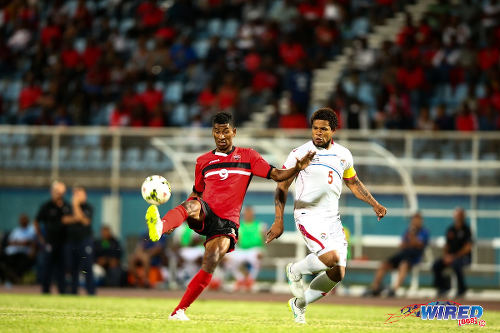 Photo: Trinidad and Tobago forward Willis Plaza (left) tries to keep the ball from Panama captain Roman Torres in friendly internal action in March 2015 at the Ato Boldon Stadium, Couva. (Courtesy Allan V Crane/Wired868)