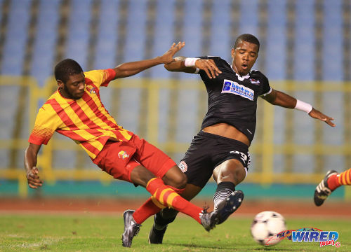 Photo: Point Fortin Civic right back Steven Joseph (left) tackles then Central FC forward Dwight Quintero in the 2014/15 Pro League season. (Courtesy Allan V Crane/Wired868)