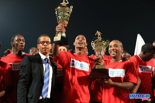 Photo: Central FC captain Leston Paul (right) holds the 2015 Akeem Adams trophy for winning the final round. Teammate Ataulla Guerra (centre) lifts the Pro League trophy while league CEO Dexter Skeene looks on. (Courtesy Alllan V Crane/Wired868)