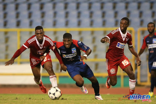 Photo: Morvant Caledonia full back Jameel Neptune (centre) is a handful for Central FC defenders Elton John (left) and Kaydion Gabriel in the 2015 Digicel Pro Bowl final. (Courtesy Allan V Crane/Wired868)