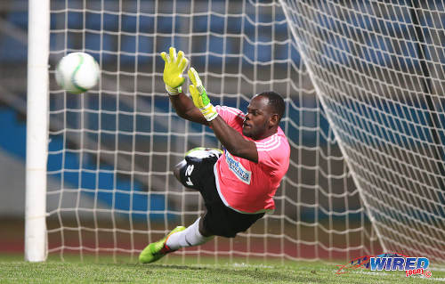 Photo: Central FC goalkeeper Jan-Michael Williams makes one of three penalty saves against Don Bosco FC in the 2015 Caribbean Club Championship semifinals. Central won 3-1 on kicks from the penalty mark. (Courtesy Allan V Crane/Wired868) 