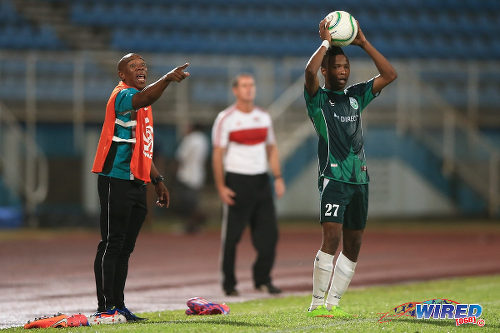 Photo: W Connection assistant coach Earl Jean (left) barks orders at his squad while right back Shannon Gomez (right) prepares to take a throw during the 2015 Caribbean Cup final. Looking on is Central FC coach Terry Fenwick. (Courtesy Allan V Crane/Wired868)