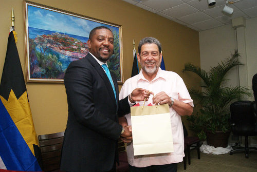 Photo: West Indies Cricket Board (WICB) president Dave Cameron (left) presents a token to St Vincent and the Grenadines Prime Minister Dr Ralph Gonsalves during a WICB-CARICOM meeting. (Courtesy Windies Cricket)