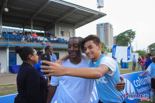 Photo: Former Trinidad and Tobago and FC Porto star Russell "Little Magician" Latapy (centre) poses with a fan during the British Airways Tobago Legends Football Challenge community outreach programme at the St Mary's College ground in Serpentine Road, St Clair. (Courtesy Sinead Peters/Wired868)