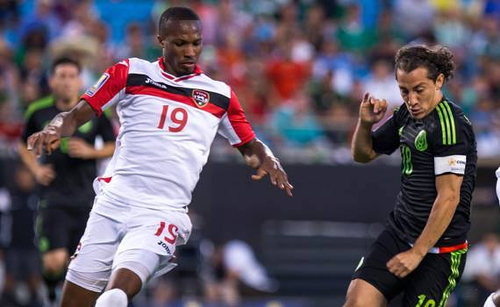 Photo: Trinidad and Tobago midfielder Kevan George (left) keeps an eye on Mexico captain Andres Guardado in 2015 CONCACAF Gold Cup action. (Courtesy CONCACAF)